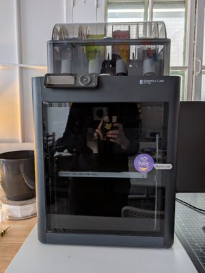 A photo of a black Bambu Lab P1S 3D printer with reels visible.