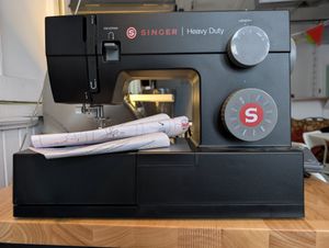 A photo of a black heavy-duty sewing machine